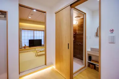 a bathroom with a sliding door and a television at M301 5 minutes walk from Minowa Station on the Hibiya Line! Direct access to Ueno, Akihabara, Tsukiji Market, Ginza! Family room for 5-6 people! in Tokyo