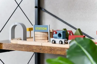 a toy train on a wooden shelf with a sign at SHINBASHI Station A major hub station ideal for Tokyo sightseeing Numerous restaurants and eateries surround the station Enjoy your stay on the top floor of the building without worrying about noise Elevator available in Tokyo