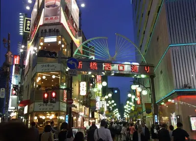 a busy city street at night with neon signs at SHINBASHI Station A major hub station ideal for Tokyo sightseeing Numerous restaurants and eateries surround the station Enjoy your stay on the top floor of the building without worrying about noise Elevator available in Tokyo