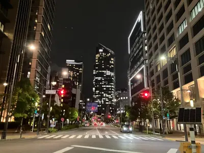 a city street at night with traffic lights and buildings at SHINBASHI Station A major hub station ideal for Tokyo sightseeing Numerous restaurants and eateries surround the station Enjoy your stay on the top floor of the building without worrying about noise Elevator available in Tokyo