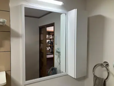 a mirror hanging on a wall in a bathroom at Asakusa, Ueno, Akihabara MAX 6 guests Entire building rental Ideal base for Tokyo sightseeing Manga, games, large-screen TV in Tokyo