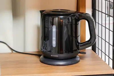 a black electric kettle sitting on a table at Asakusa, Ueno, Akihabara MAX 6 guests Entire building rental Ideal base for Tokyo sightseeing Manga, games, large-screen TV in Tokyo