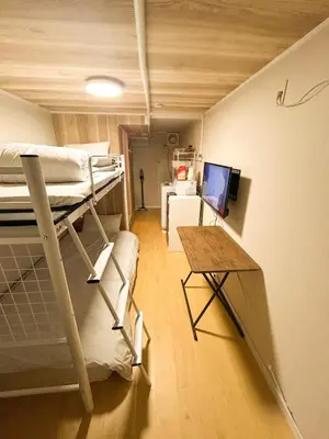 a room with two bunk beds and a desk at 103 Shin Okubo area & Quiet stay in central of Tokyo in Tokyo