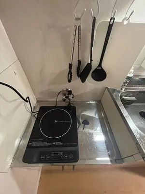 a laptop sitting on a counter next to a sink at 103 Shin Okubo area & Quiet stay in central of Tokyo in Tokyo