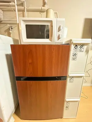 a microwave sitting on top of a wooden counter at 103 Shin Okubo area & Quiet stay in central of Tokyo in Tokyo