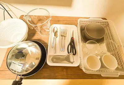 a table with plates and utensils on it at 103 Shin Okubo area & Quiet stay in central of Tokyo in Tokyo