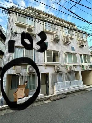 a view of a building from a rear view mirror at 103 Shin Okubo area & Quiet stay in central of Tokyo in Tokyo