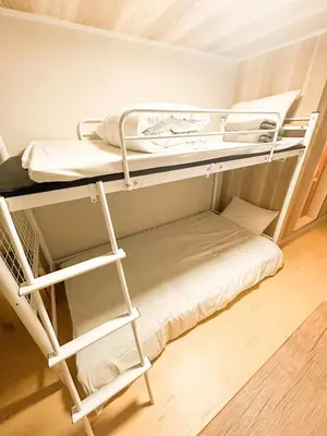 a bunk bed room with two bunk beds and a ladder at 103 Shin Okubo area & Quiet stay in central of Tokyo in Tokyo