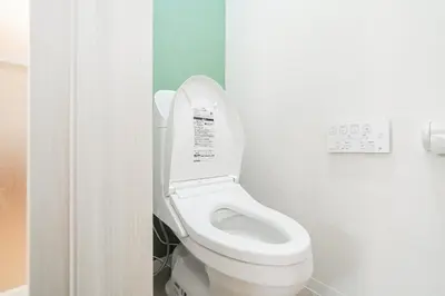 a bathroom with a white toilet in a stall at C1 Shibuya, 2 bedrooms and 1 living room 2 bathrooms 2 toilets, 7 mins to ST Max 6P \u6e0b\u8c37\u5168\u65b0\u88c5\u4fee \u4e24\u5ba4\u4e00\u5385 \u4ea4\u901a\u4e2d\u5fc3 \u8f66\u7ad97\u5206\u949f \u6700\u59276\u4eba \u76f4\u8fbe\u65b0\u5bbf \u6d89\u8c37 \u8868\u53c2\u9053 \u54c1\u5ddd \u6c60\u888b \u4e0a\u91ce \u4ee3\u4ee3\u6728 \u94f6\u5ea7 \u539f\u5bbf in Tokyo