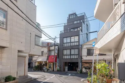 an empty street in a city with tall buildings at \u6d45\u8349\u30de\u30a4\u30db\u30c6\u30eb Asakusa My apartment Hotel in Tokyo