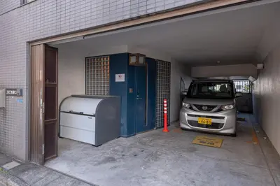 a garage with a car parked inside of it at \u6d45\u8349\u30de\u30a4\u30db\u30c6\u30eb Asakusa My apartment Hotel in Tokyo