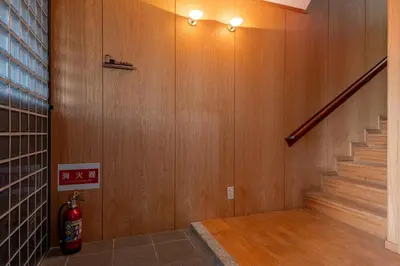 a room with a staircase with a fire hydrant next to a wall at \u6d45\u8349\u30de\u30a4\u30db\u30c6\u30eb Asakusa My apartment Hotel in Tokyo