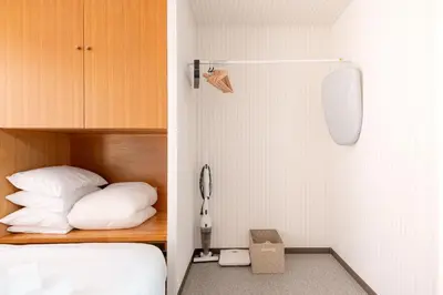 a small room with a bed at \u6d45\u8349\u30de\u30a4\u30db\u30c6\u30eb Asakusa My apartment Hotel in Tokyo