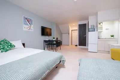 a bedroom with a bed and a kitchen with a table at Astra Nakano hostel max6 people NN0494 in Tokyo