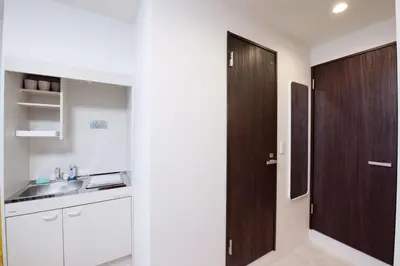a kitchen with a brown door and a sink at Astra Nakano hostel max6 people NN0494 in Tokyo