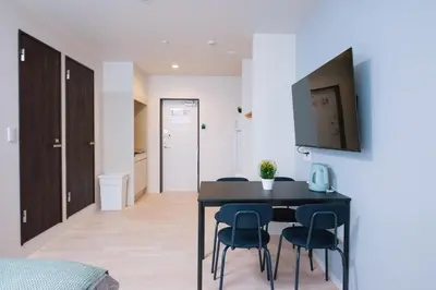 a dining room with a black table and chairs at Astra Nakano hostel max6 people NN0494 in Tokyo