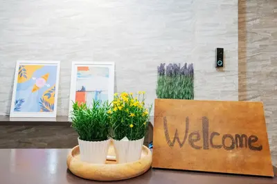 a welcome sign sitting on a table with flowers at Astra Nakano hostel max6 people NN0494 in Tokyo