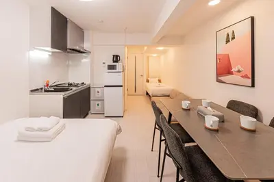a kitchen and dining room with a table and chairs at Crecer Apartment Hotel kamata in Tokyo