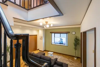 a living room with a couch and a staircase at Kotori Ayase in Tokyo