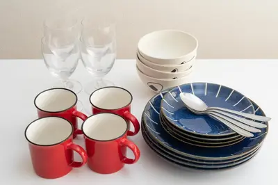 a table with red cups and plates and wine glasses at Kotori Ayase in Tokyo