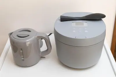 a coffee maker with a black bow on top of it at Kotori Ayase in Tokyo