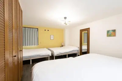 a hospital room with two beds and a window at Kotori Ayase in Tokyo