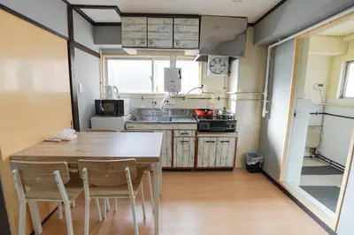 a kitchen with a table and chairs in a room at 203Room 1 Stop from Ikebukuro Entire 35m on 2st Floor 2 Bedrooms for up to 6 Guests 3Minute Walk to Don Quijote in Tokyo