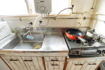 a kitchen with a sink and a pot on a stove at 203Room 1 Stop from Ikebukuro Entire 35m on 2st Floor 2 Bedrooms for up to 6 Guests 3Minute Walk to Don Quijote in Tokyo