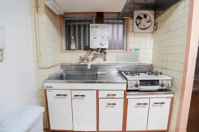 a kitchen with a sink and a stove at 201Room 1 Stop from Ikebukuro Entire 33m on 2st Floor 2 Bedrooms for up to 6 Guests 3Minute Walk to Don Quijote in Tokyo
