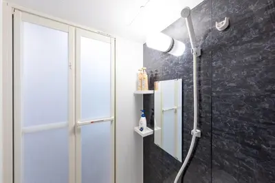 a shower in a bathroom with a glass door at Tokyo 3min Gotanno Station couples friends 20sqm in Tokyo