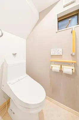 a bathroom with a white toilet and a window at MaiMai Yahiro in Tokyo