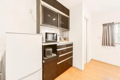 a kitchen with a refrigerator and a microwave at MaiMai Yahiro in Tokyo