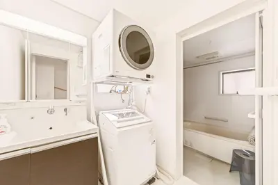 a white bathroom with a sink and a tub at MaiMai Yahiro in Tokyo