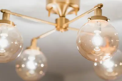 a chandelier with three glass globes on it at MaiMai Yahiro in Tokyo