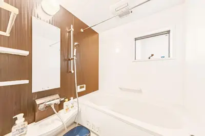 a bathroom with a white tub and a sink at MaiMai Yahiro in Tokyo