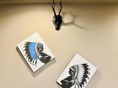 three cards hanging on a wall with a antelope head at Tokyo ShinjukStation 800meters kabukicho2minutes 403 in Tokyo