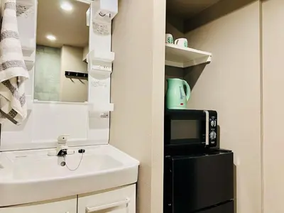 a small kitchen with a sink and a microwave at Tokyo ShinjukStation 800meters kabukicho2minutes 403 in Tokyo