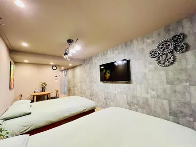 a bedroom with two beds and a tv on the wall at Tokyo ShinjukStation 800meters kabukicho2minutes 403 in Tokyo