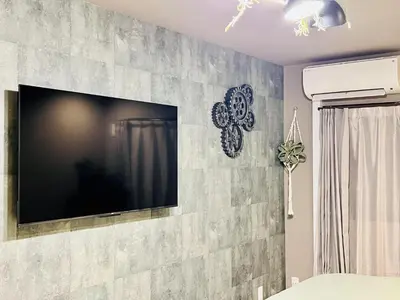 a flat screen tv on a stone wall at Tokyo ShinjukStation 800meters kabukicho2minutes 403 in Tokyo