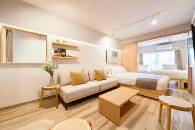 a hotel room with a bed and a couch at Second Home SHIBUYA in Tokyo