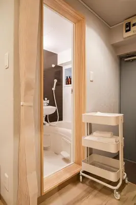 a bathroom with a large mirror and a sink at Second Home SHIBUYA in Tokyo