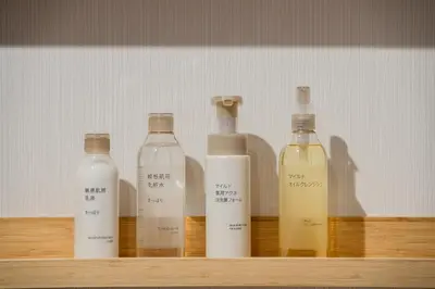 a row of bottles sitting on a wooden shelf at Second Home SHIBUYA in Tokyo