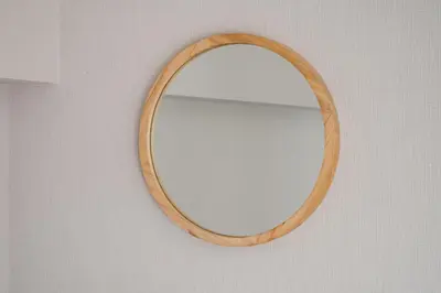a wooden mirror hanging on a wall at Second Home SHIBUYA in Tokyo