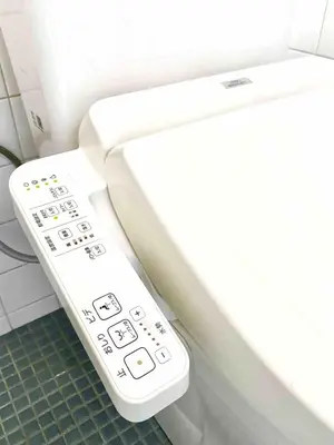 a remote control on a toilet in a bathroom at 2BR 35m2 Bright Parkside Apt - JR 8 min Shinjuku in Tokyo