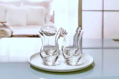 two glass vases on a plate on a table at 2BR 35m2 Bright Parkside Apt - JR 8 min Shinjuku in Tokyo
