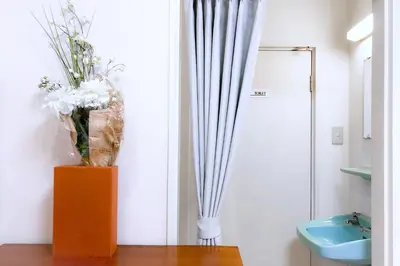 a vase of flowers sitting on a table in a bathroom at 2BR 35m2 Bright Parkside Apt - JR 8 min Shinjuku in Tokyo