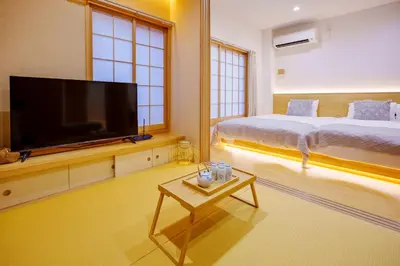 a bedroom with a flat screen tv and a bed at M302 Hibiya Line Sannotsu Station 5 min by foot! First line direct to Ueno, Akihabara, Tsukiji Market, Ginza!Close to Asakusa Temple!! in Tokyo