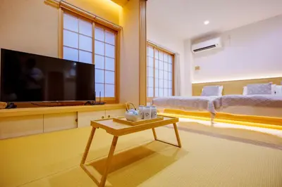a room with a tv and a bed and a table at M302 Hibiya Line Sannotsu Station 5 min by foot! First line direct to Ueno, Akihabara, Tsukiji Market, Ginza!Close to Asakusa Temple!! in Tokyo