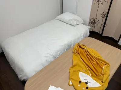 a yellow bag sitting on top of a bed at Direct access to major Tokyo stations including Shibuya, Shinjuku, Ikebukuro, Akihabara, and Ueno 3-minute walk from nearest station Tokyo Dome Suitable for long-term stays 101 in Tokyo