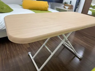 a wooden table sitting on the floor next to a bed at Direct access to major Tokyo stations including Shibuya, Shinjuku, Ikebukuro, Akihabara, and Ueno 3-minute walk from nearest station Tokyo Dome Suitable for long-term stays 101 in Tokyo